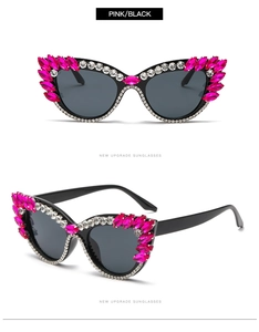 Detail of cat eye sunglasses with pink and white rhinestones on black frames