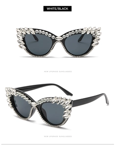 Detail showing crystal-embossed cateye sunglasses with diamond accents on black frame