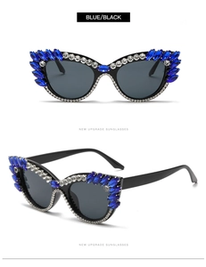 Close-up of cat-eye sunglasses with blue marquise crystals and white rhinestones