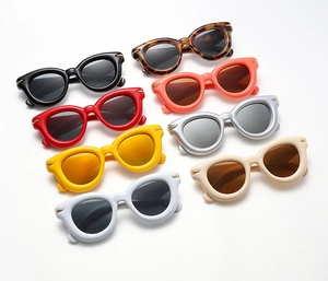 Flat lay of retro oval sunglasses in eight colors with stylish metallic hinge details