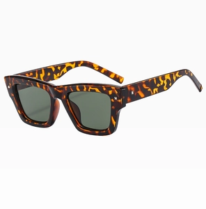 Detailed close-up of retro square tortoiseshell sunglasses with silver metal studs