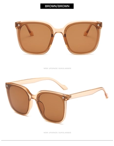 Gros plan sur des lunettes de soleil carrées marron avec rivets étoile et verres teintés