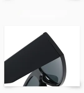 Detail view of glossy black wide-temple sunglasses frame with high-quality hinges