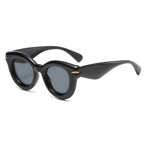 Retro thick-frame oval sunglasses for women with black glossy finish and gold metal accents