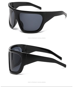Side view detail of oversized black shield sunglasses with polished frames and dark lenses