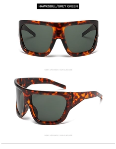 Detail of oversized flat top tortoise shell sunglasses with dark green lenses
