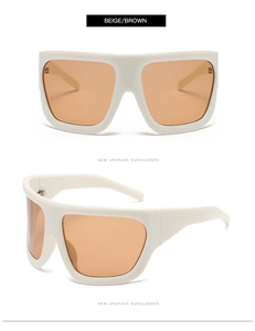 Detail of oversized beige frames with gradient brown lenses on modern sunglasses
