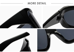 Macro view of polished black oversized sunglasses frame with hinge and nose pad details