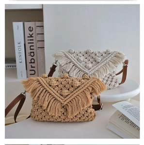 Close-up of bohemian woven cotton bag with fringed flap and 3D textured dots detail