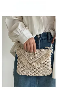 Detail of bohemian macrame crossbody bag with handmade V-shaped textures and long tassels