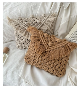 Detailed close-up of handmade woven cotton bags with boho fringe and textured knit detail