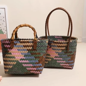 Detail of colorful woven tote bags featuring bamboo and soft handles in retro style