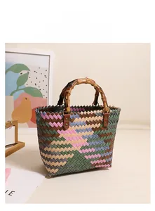 Macro detail of colorful woven beach bag with bamboo handles and vintage faux leather buckles