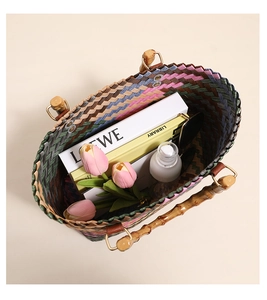 Detail of colorful woven tote bag with bamboo handle showing internal storage capacity