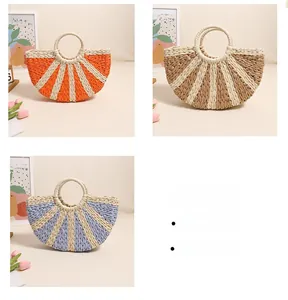 Detailed view of handmade woven straw bags in orange, khaki, and purple with ring handles