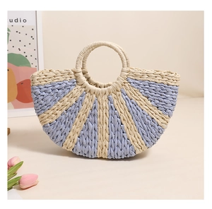 Detailed macro view of woven semicircular straw handbag with beige and blue stripes