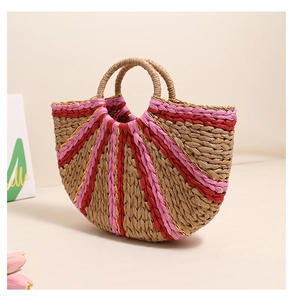 Detail of semi-circular straw bag showing pink and red striped weave and texture