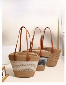 Detailed texture of hollow striped straw tote bags with brown leather handles for beach