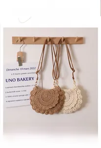 Detail of hand-crocheted hollow lace pattern on bohemian cotton woven crossbody bag