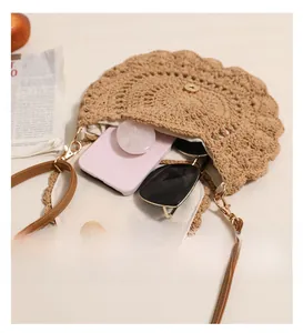 Detailed interior of hollow lace woven crossbody bag showing phone and sunglasses