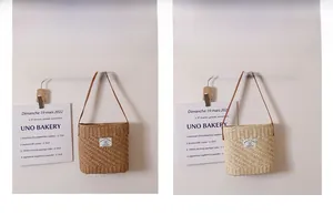 Detail view of woven straw shoulder bag textures in dark wood and light beige colors