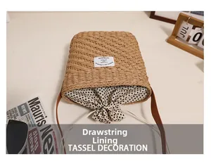Detail of square straw bag showing black and white polka dot drawstring lining and fabric label