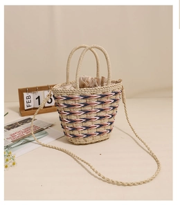 Detail of woven straw bucket bag with blue stripes and secure drawstring lining