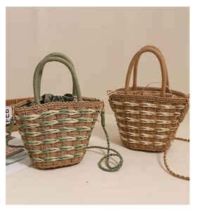 Detail of two straw woven crossbody bags with drawstring liners and round handles