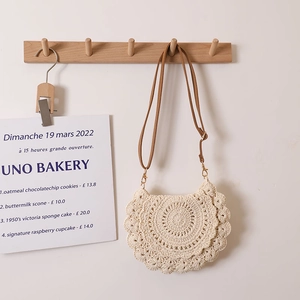 Handwoven ivory crochet crossbody bag with scalloped edges and leather shoulder strap