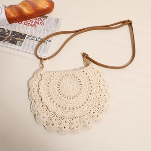 Beige hollow crochet crossbody bag with tiered shell texture and brown leather strap