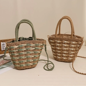 Handwoven straw bucket bag in green and khaki with drawstring lining for beach vacations