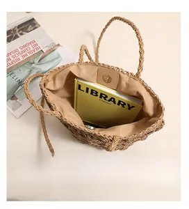 Spacious interior of hollow flower woven straw tote bag with magnetic closure