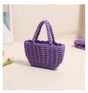 Detail view of light purple hand-woven cotton bag with V-shaped texture and dual handles