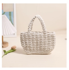Close-up detail of cream cotton rope woven handbag with textured handmade patterns