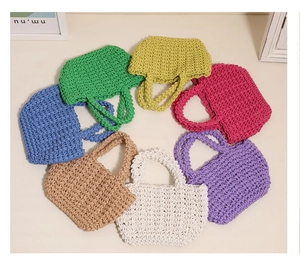 Close-up of various colorful handmade cotton rope woven mini bags in diverse vibrant hues