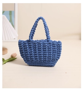 Detail of dark blue handmade crochet handbag with thick texture and minimalist design