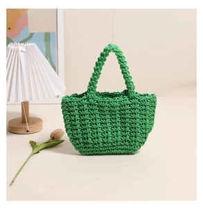 Close-up of vibrant green cotton rope woven handbag with thick crochet texture and handles