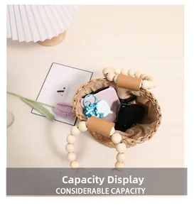 Top view of woven straw bucket bag showing internal capacity for phone and sunglasses