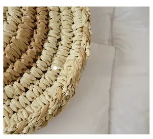 Macro shot of natural straw woven texture and detailed bicolor spiral pattern on round bag