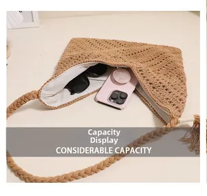 Detail view of cotton woven crossbody bag showing large interior for phone and sunglasses