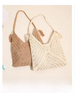 Detailed knit texture of triangular crochet bags with decorative side tassels