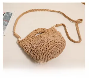 Detail of hand-woven cotton texture and detachable strap hooks on khaki crochet bag