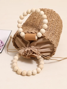 Cute straw bucket bag with wooden bead handles and drawstring liner for beach holidays