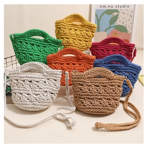 Detail of colorful hand-woven crochet mini bags with hollow patterns and straps