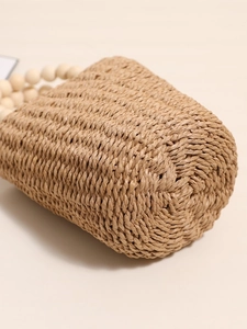 Handcrafted straw bucket bag with beaded wooden handle for beach and vacation style