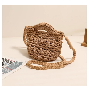 Detailed view of hand-woven cotton rope texture on a light brown mini bucket bag