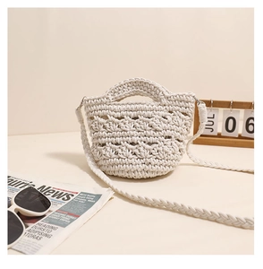 Detail of white handmade crochet texture and bohemian woven strap on a beach bag
