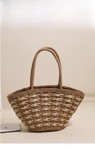 Close-up of a woven straw shoulder bag featuring natural brown and white stripe patterns
