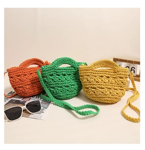 Detailed texture of vibrant hand-woven cotton mini bags in orange, green, and yellow