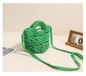 Detailed close-up of vibrant green woven cotton shoulder bag with handcrafted texture